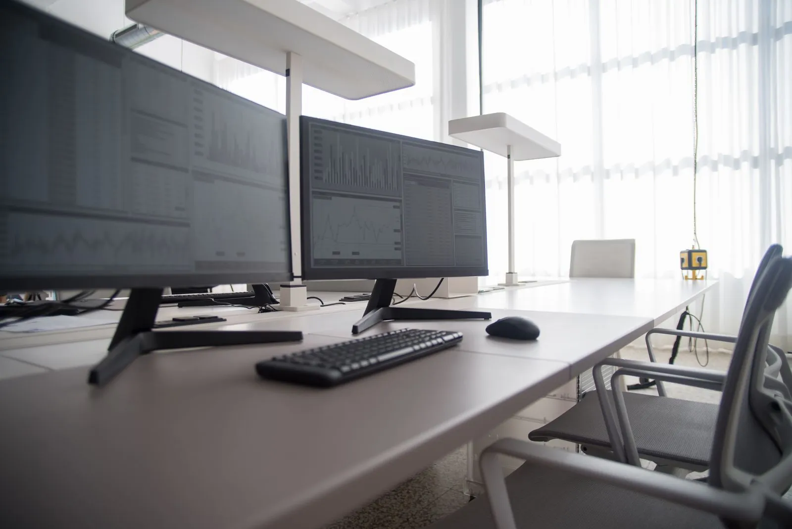 Laptop screen showing an AI assistant interface on a desk in a modern workspace
