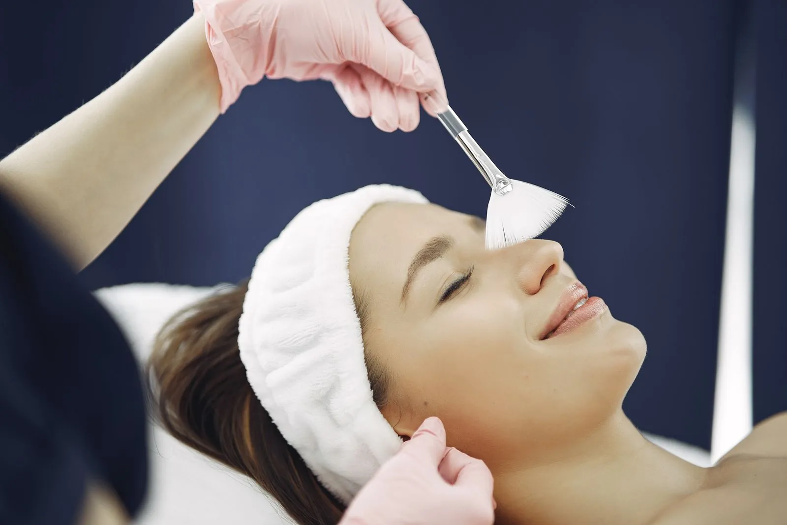 Client relaxing during a facial treatment in a serene med spa room